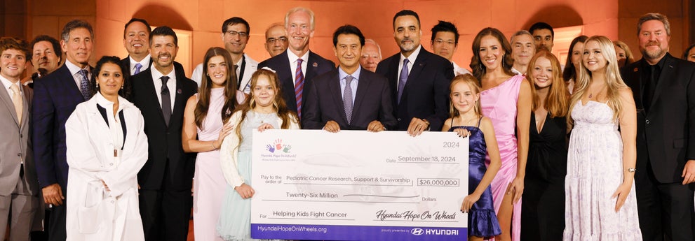 helping kids fight cancer foundation showing their big check from hyundai hope on wheels - Millennium Hyundai in Hempstead NY
